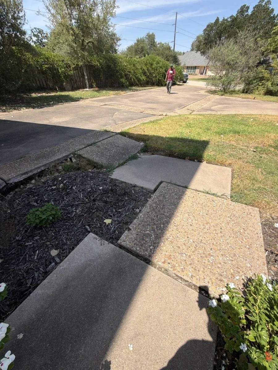 Before the work: a broken walkway leading to the street